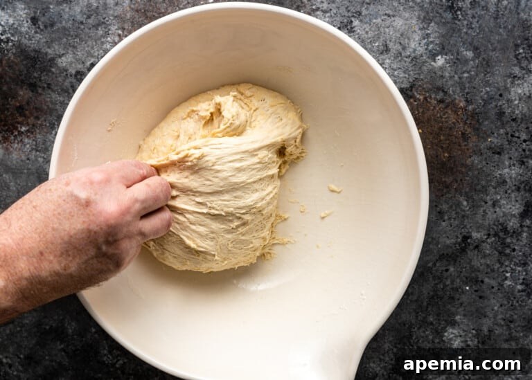 Beloved Turkish Ramadan Pide 12 A hand repeating the pulling and folding motion of the dough, building structure.