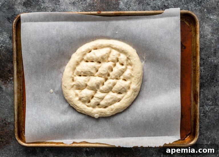 Beloved Turkish Ramadan Pide 19 Fingertips creating diagonal lines within the circular indentation on Ramazan Pidesi dough, forming the start of the diamond pattern.