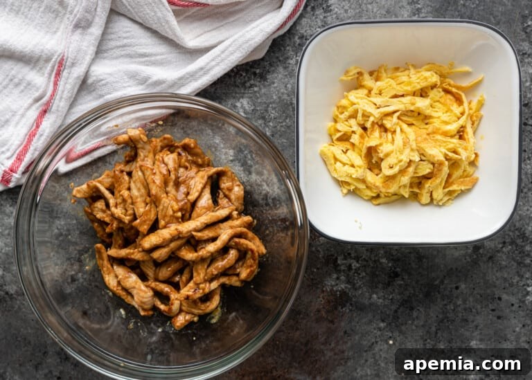 cooked pork and thinly sliced egg in separate bowls