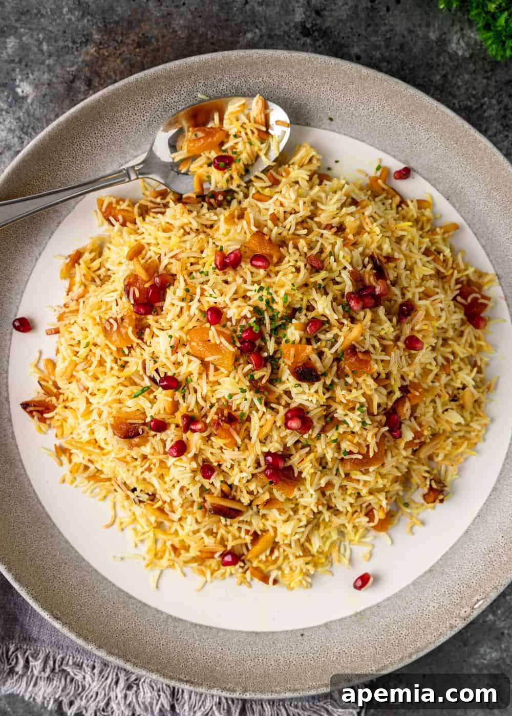 overhead: a serving of my persian saffron rice recipe with apricots and pomegranate seeds