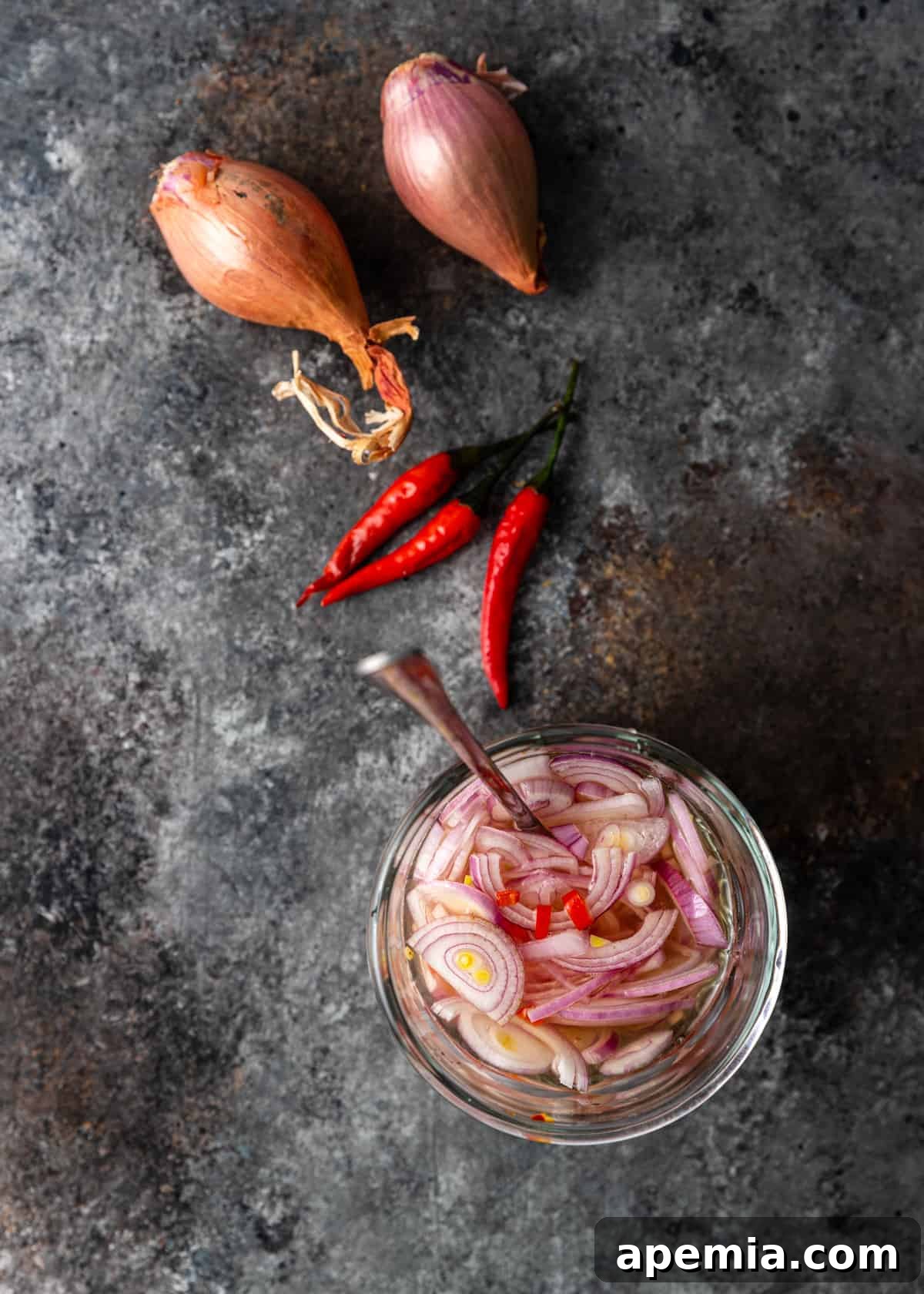 overhead: sliced shallots in vinegar with chiles for my gua bao recipe