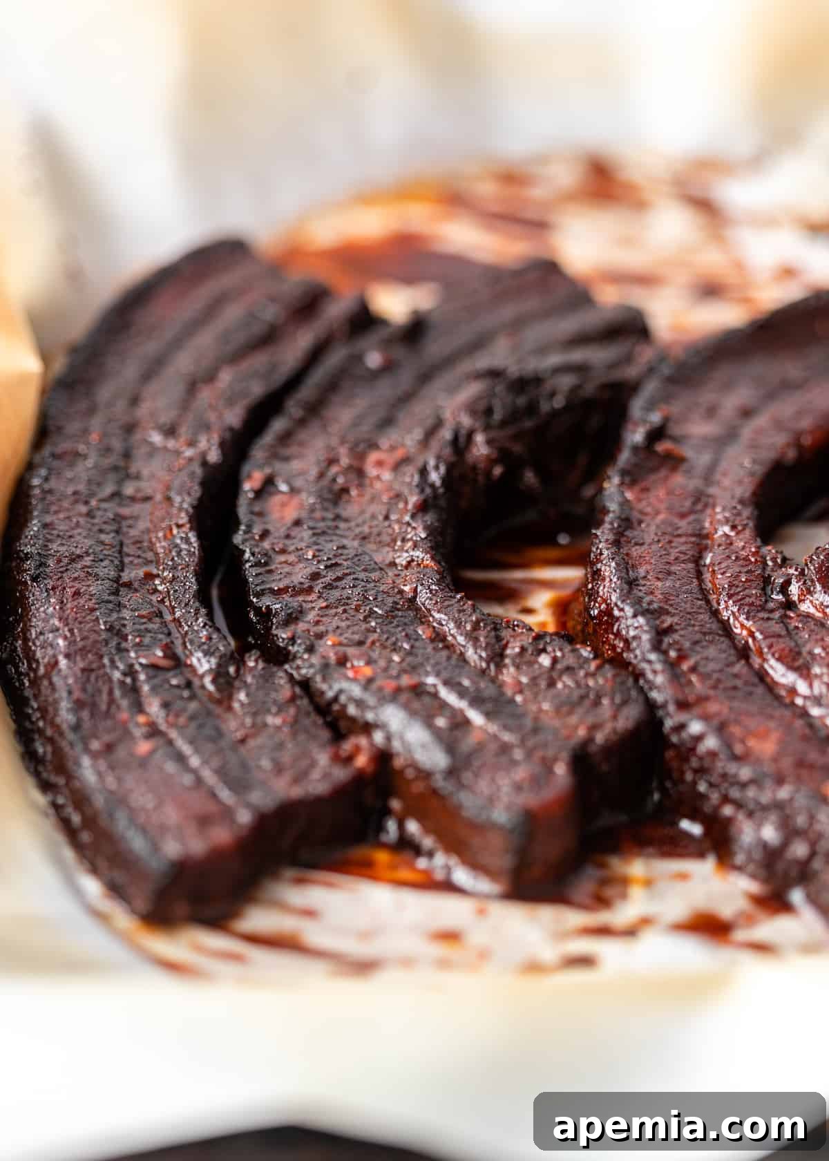 closeup: slices of glazed pork belly