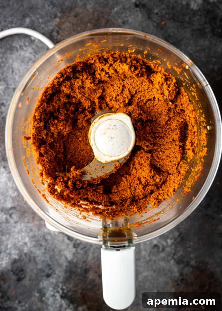 overhead process shot: the final grinding process to achieve a thick, smooth panang curry paste
