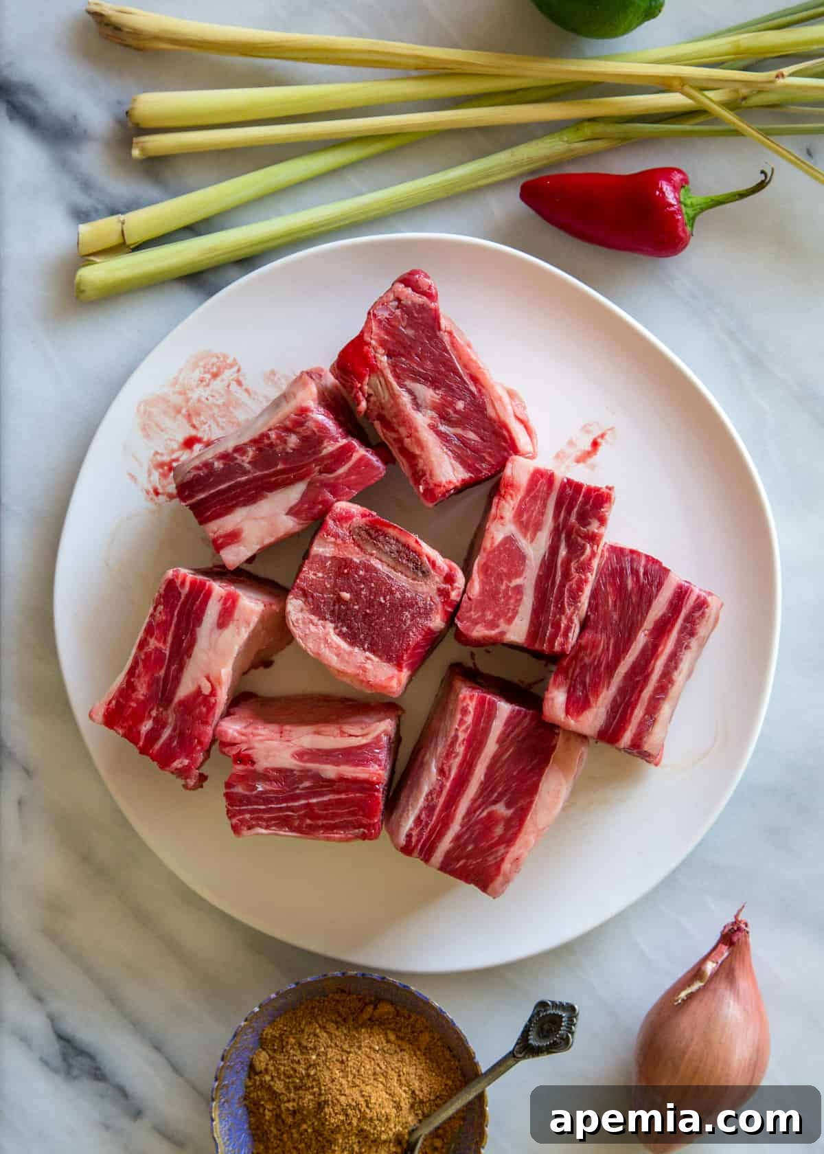Slow-Cooked Malaysian Beef Short Ribs 4 raw short ribs on a platter