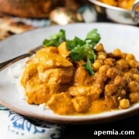 butter chicken with chickpea masala on white plate