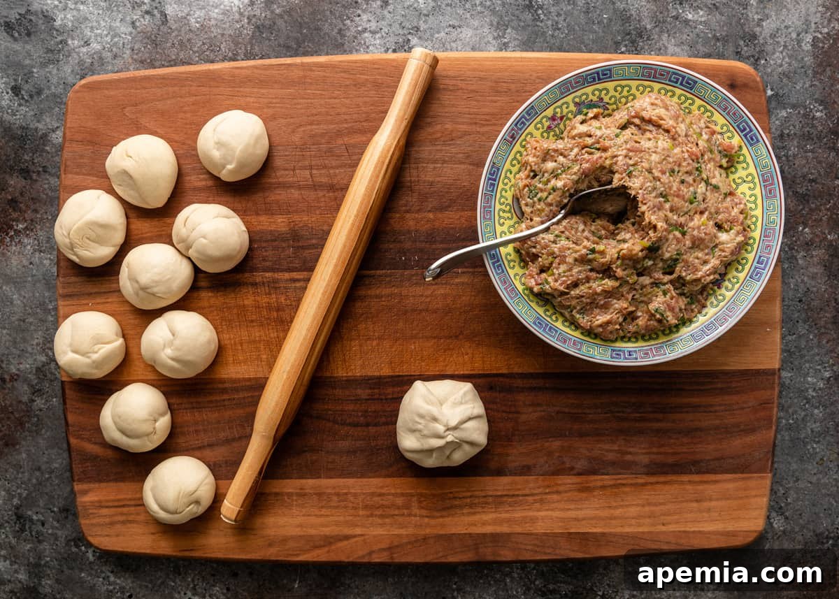 Pinching the edges of the dough over the filling to seal the Chinese Meat Pie