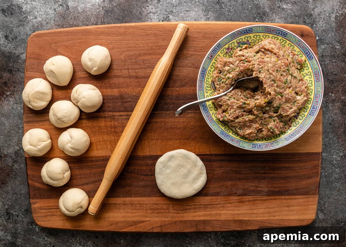 Gently flattening the assembled Chinese Meat Pie into a round disc