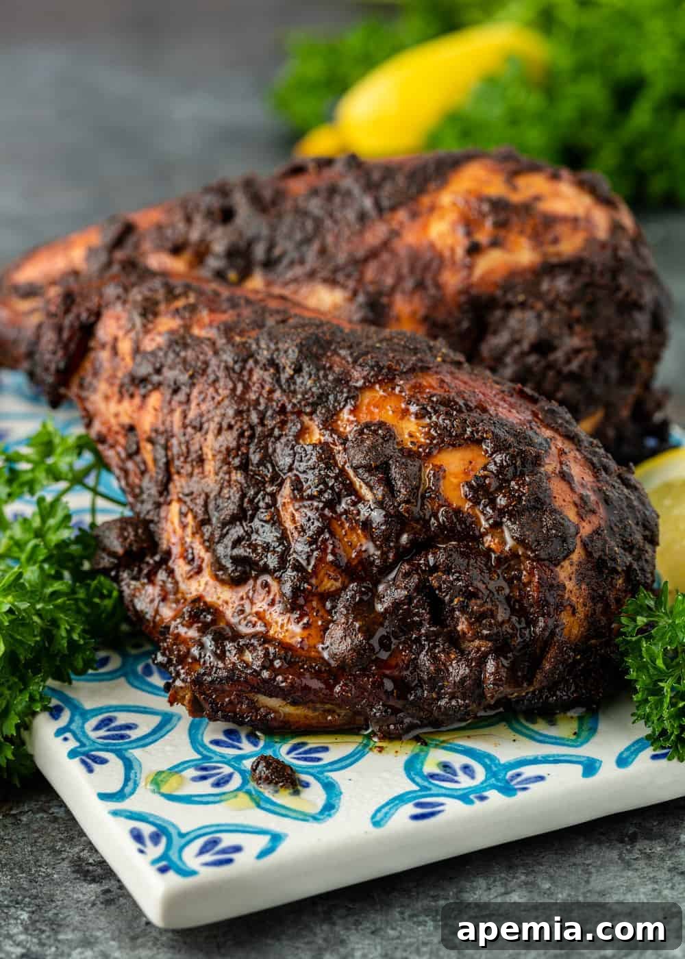 Close-up of charred Iraqi grilled chicken pieces, showing the crispy skin and flavorful seasoning.