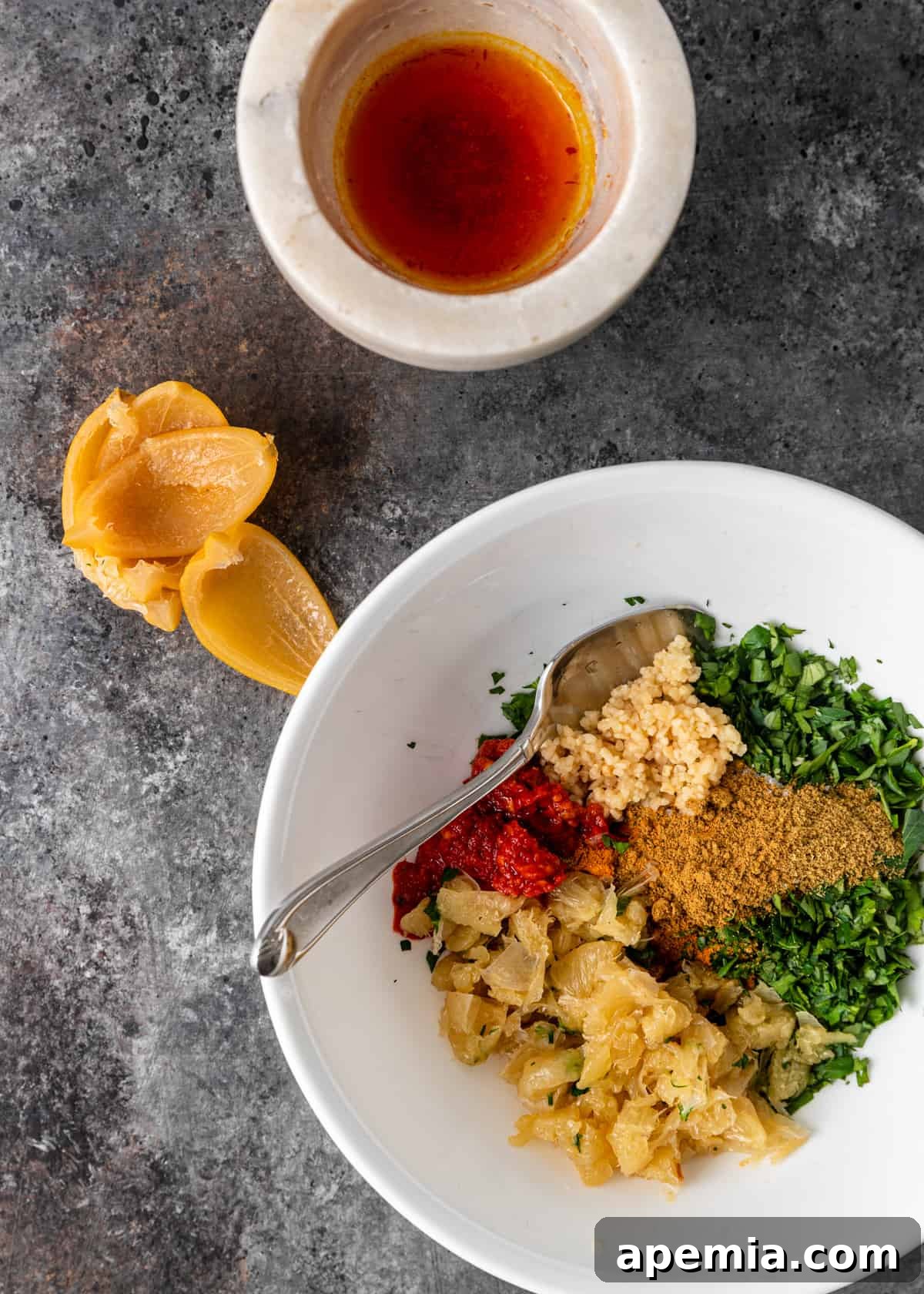 Overhead view: fresh ingredients being prepared and chopped for a chermoula recipe.