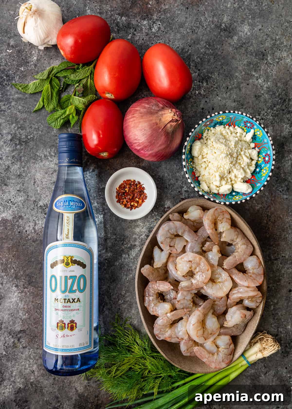 Overhead shot of all the fresh ingredients laid out, ready to make the Shrimp Saganaki recipe.