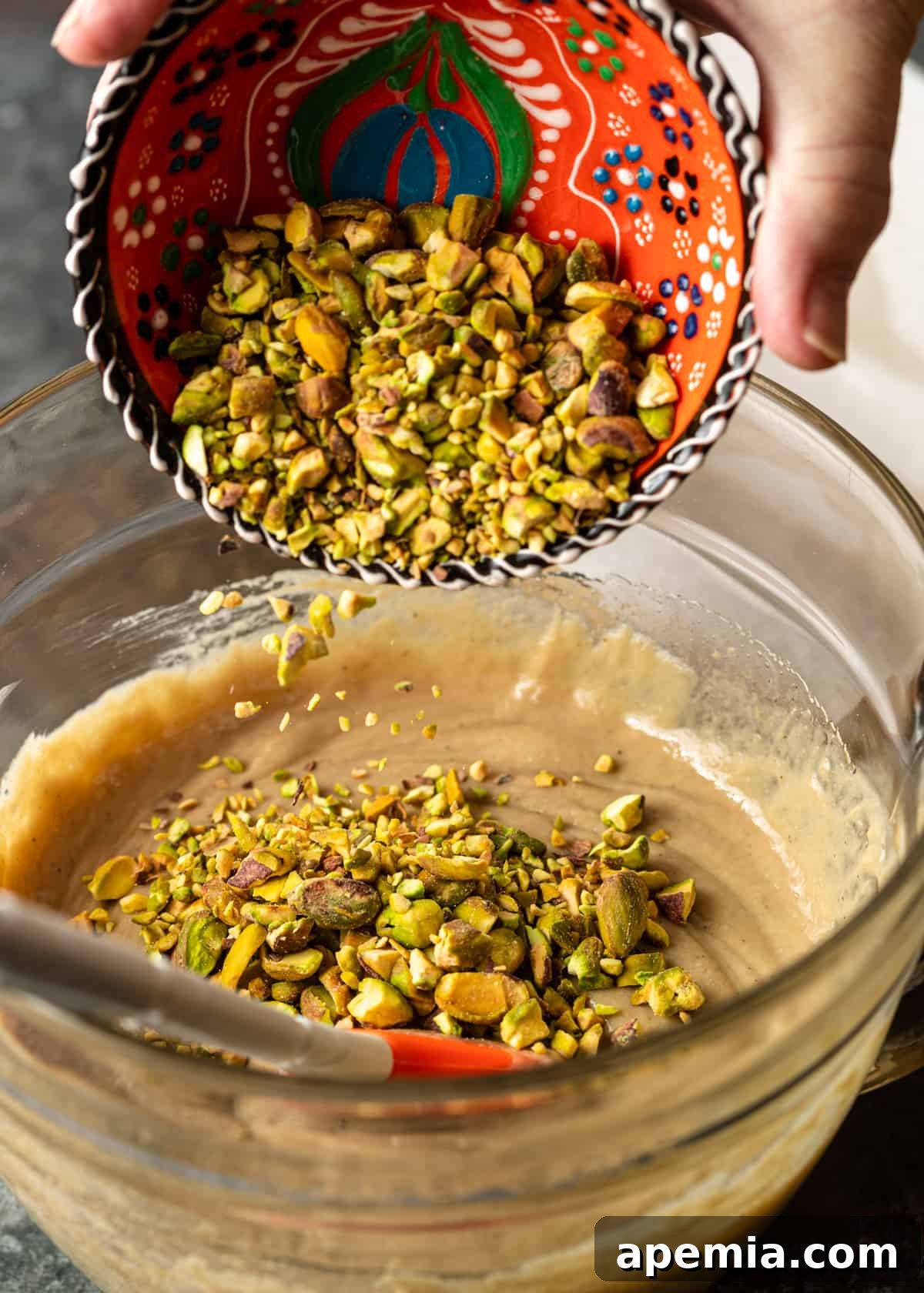 Process shot: Adding pistachios to halva batter