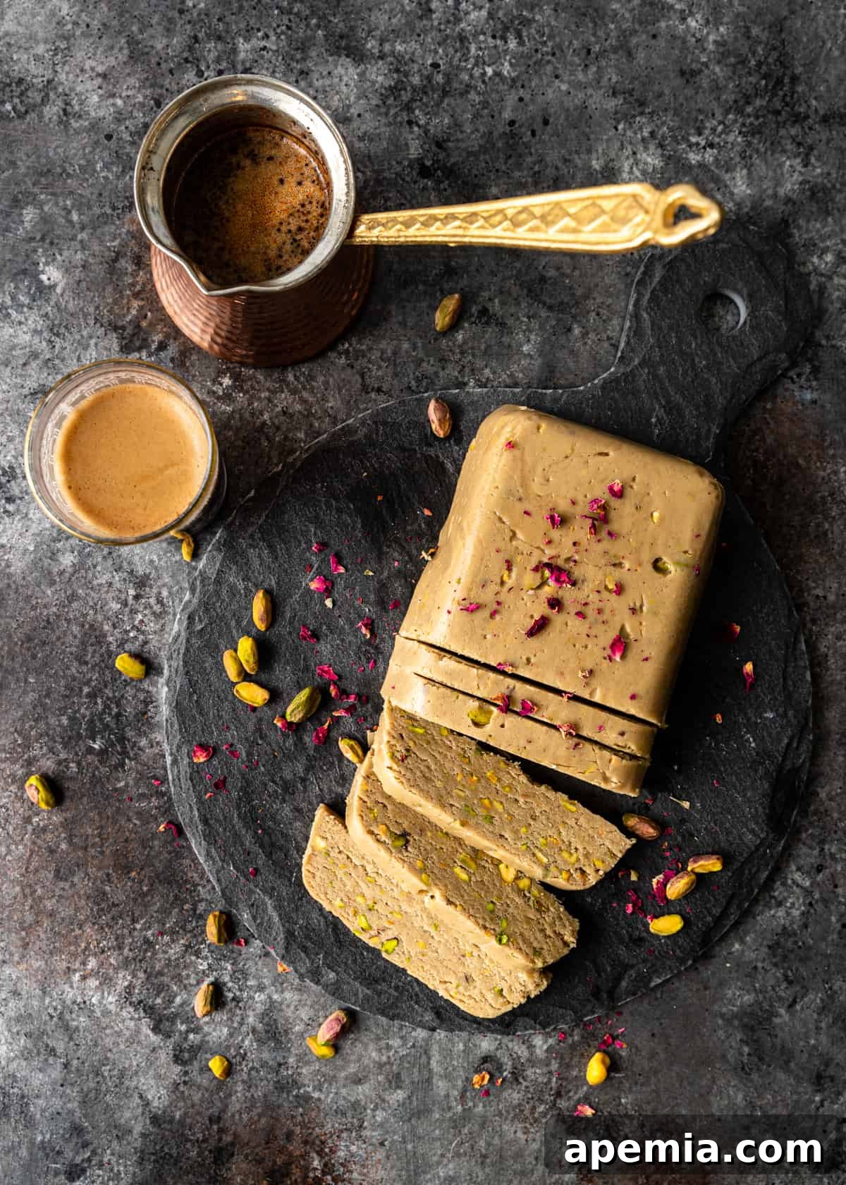 Overhead shot of a loaf of homemade halva, neatly cut into slices.