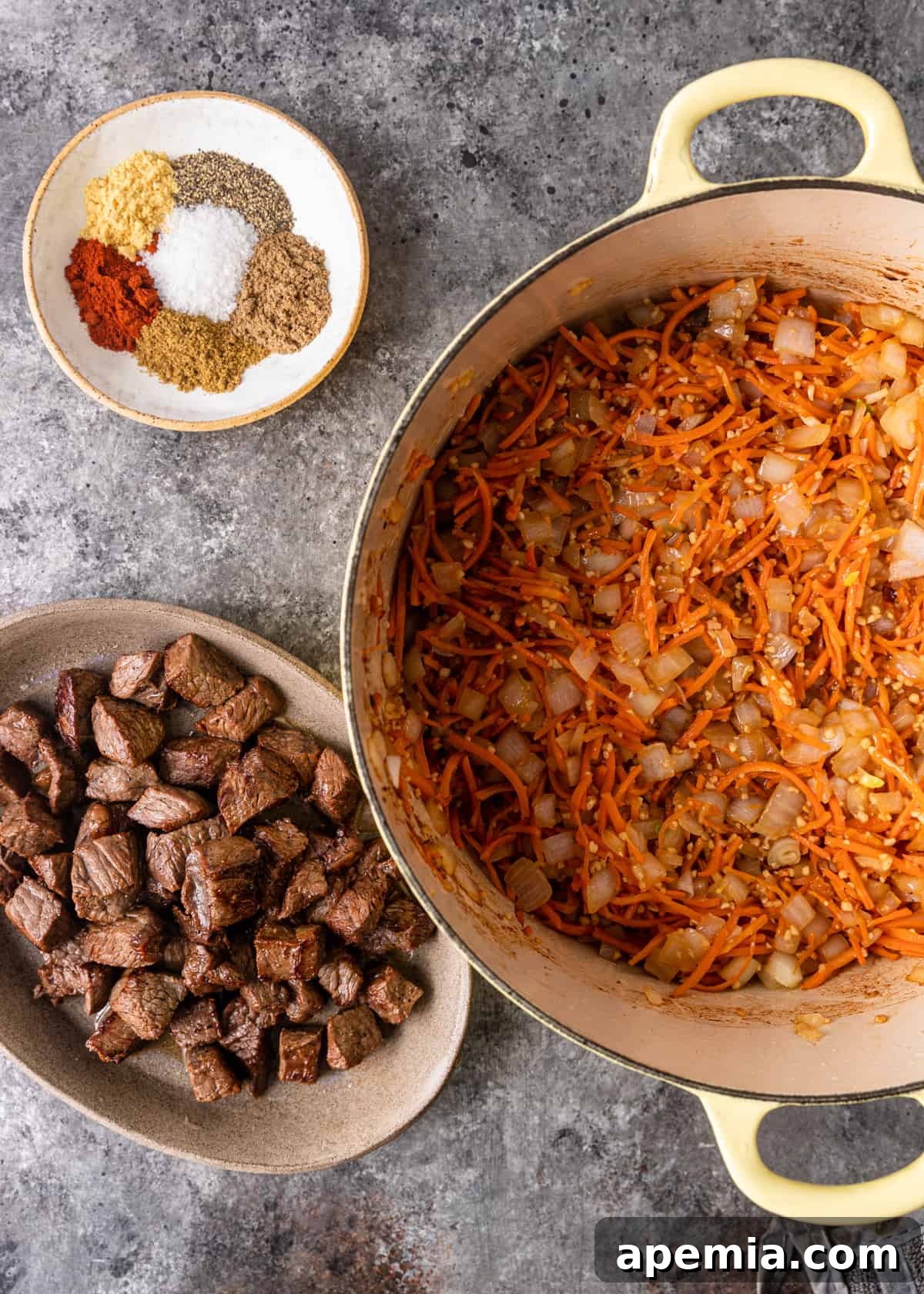 overhead: dutch oven with cooked beef rice pilaf ingredients before assembling