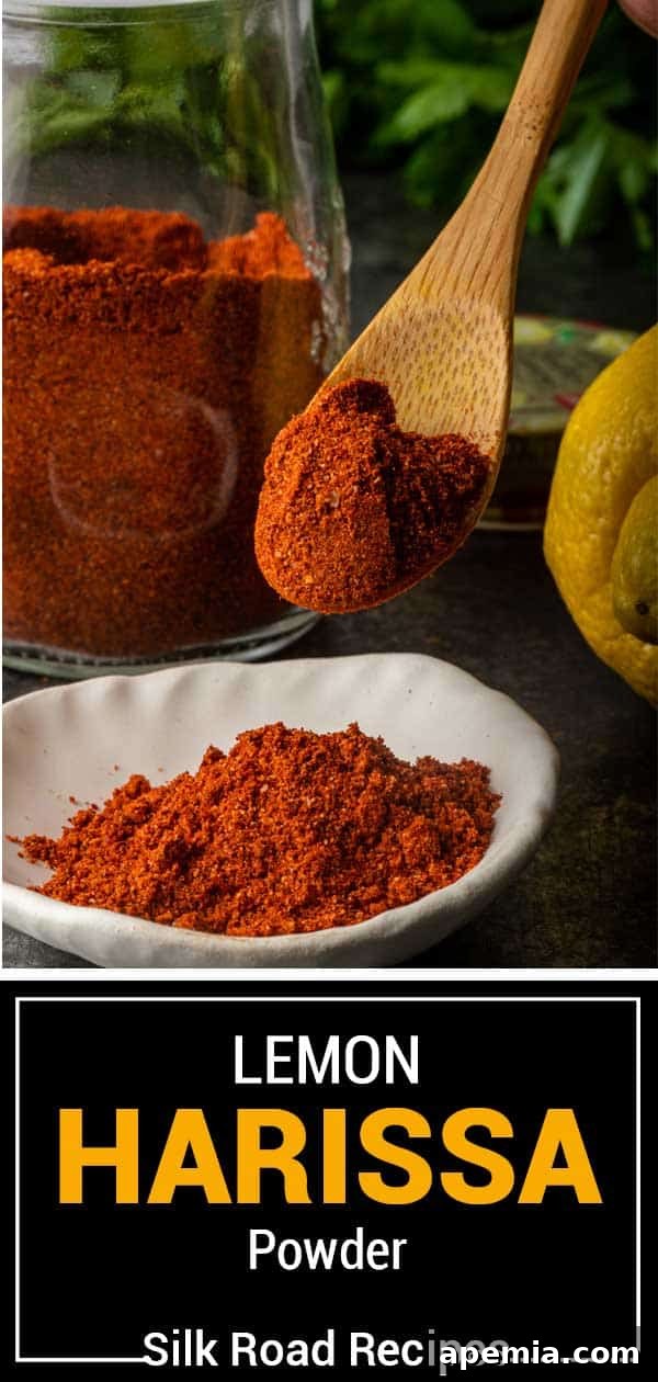 Side view of a glass jar with Lemon Harissa Powder, emphasizing its texture and volume.