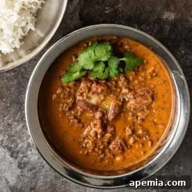 Ultimate Creamy Dal Makhani 8 lentils in copper bowl with melted butter and cilantro on top