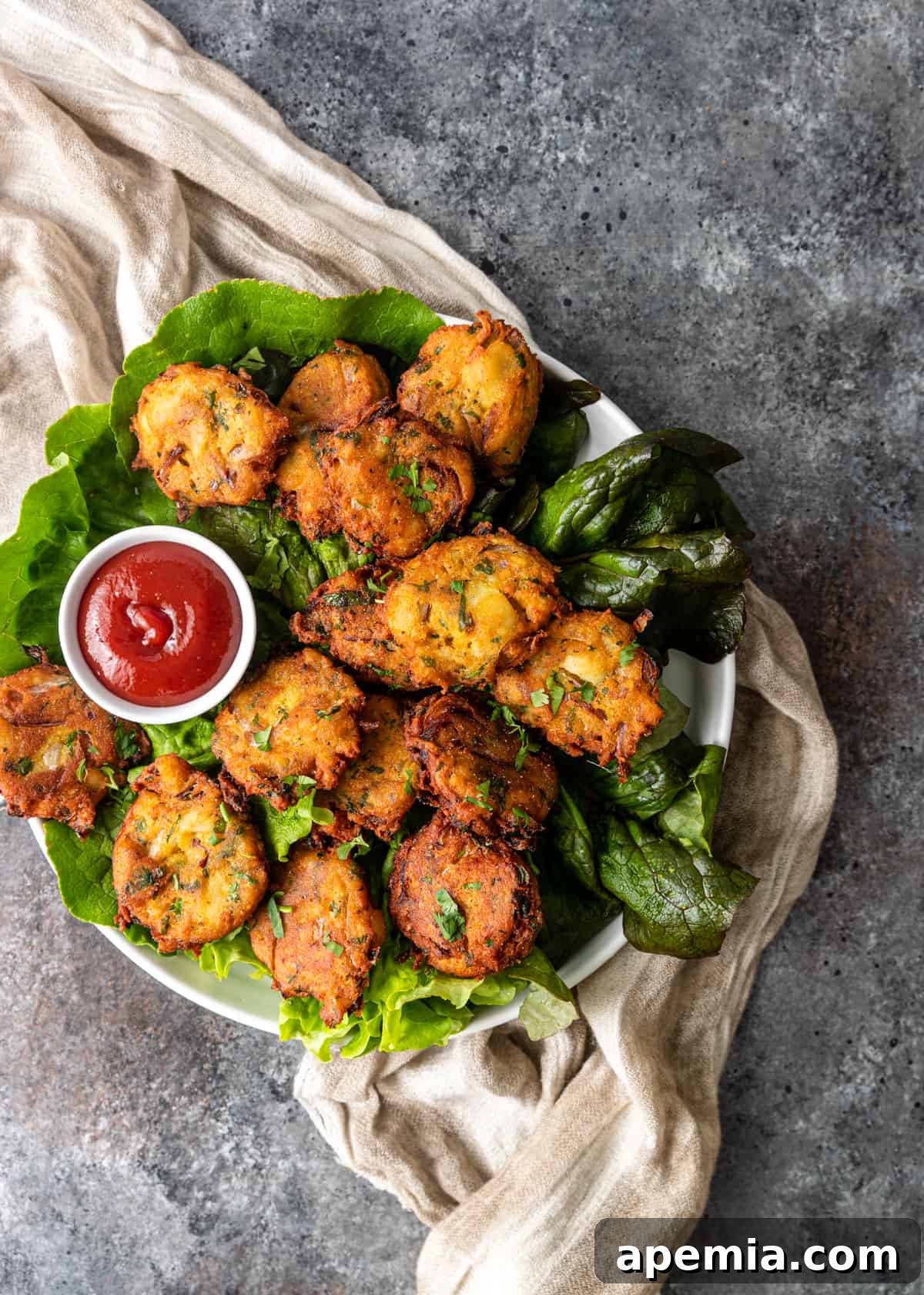 platter with dipping sauce and Potato Pakora