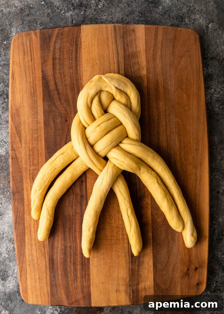 Process shot: Almost complete Challah braid, demonstrating the even and tight weave.