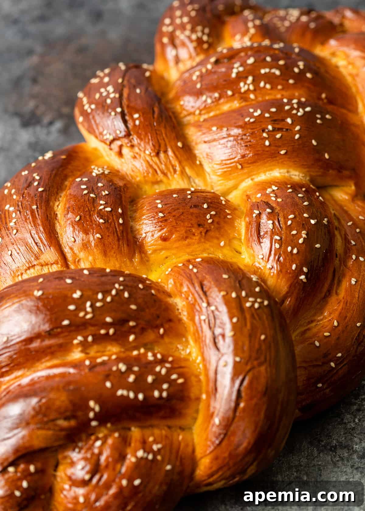 Close-up side view of a sliced Challah bread, showing its fluffy interior and golden crust.