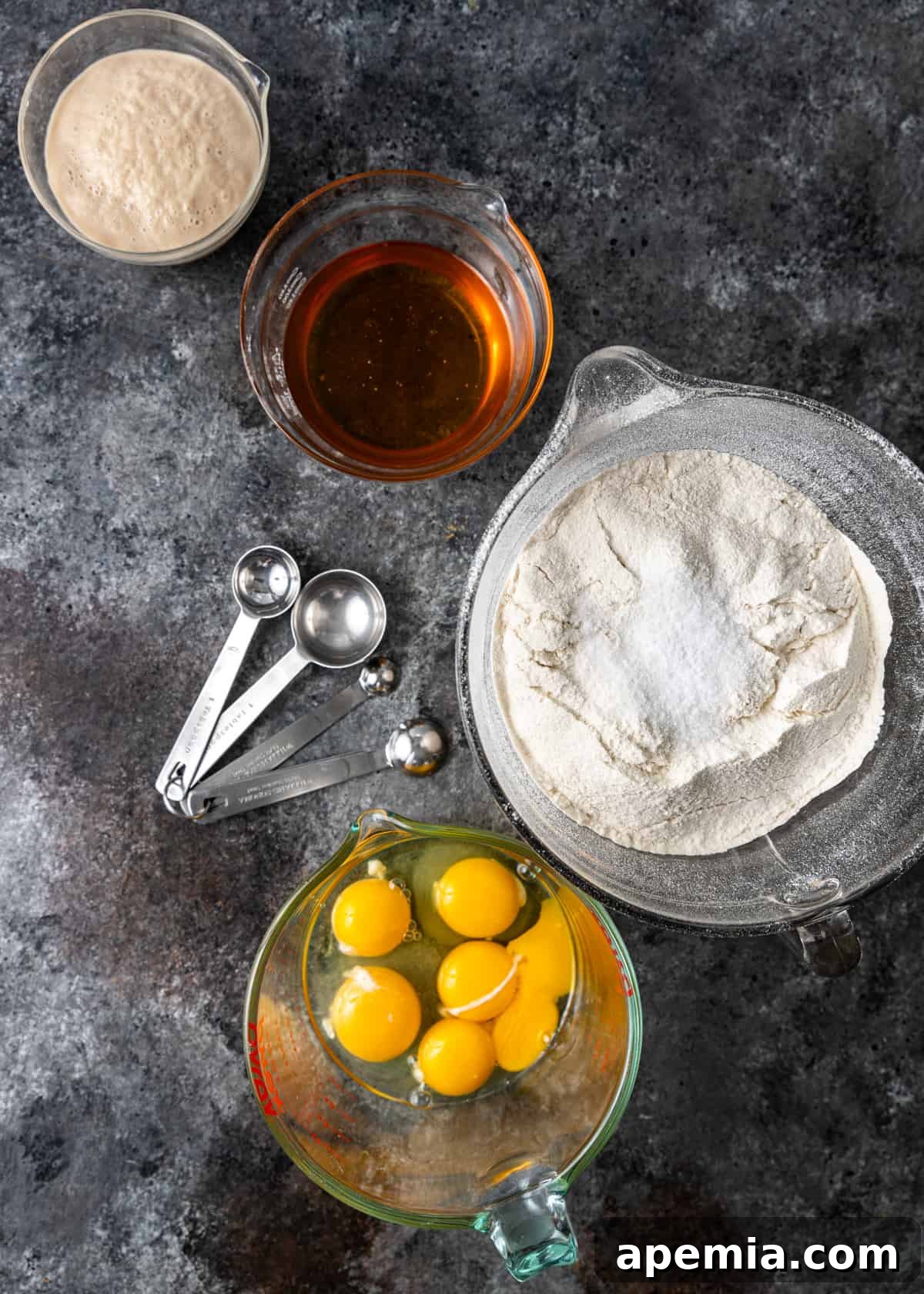 Overhead view of all the fresh ingredients laid out on a table, ready to be used for making Challah bread.