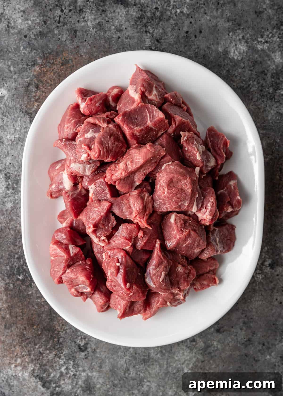 Zesty Goan Lamb Vindaloo 5 overhead process shot: trimmed and cut lamb shoulder on plate