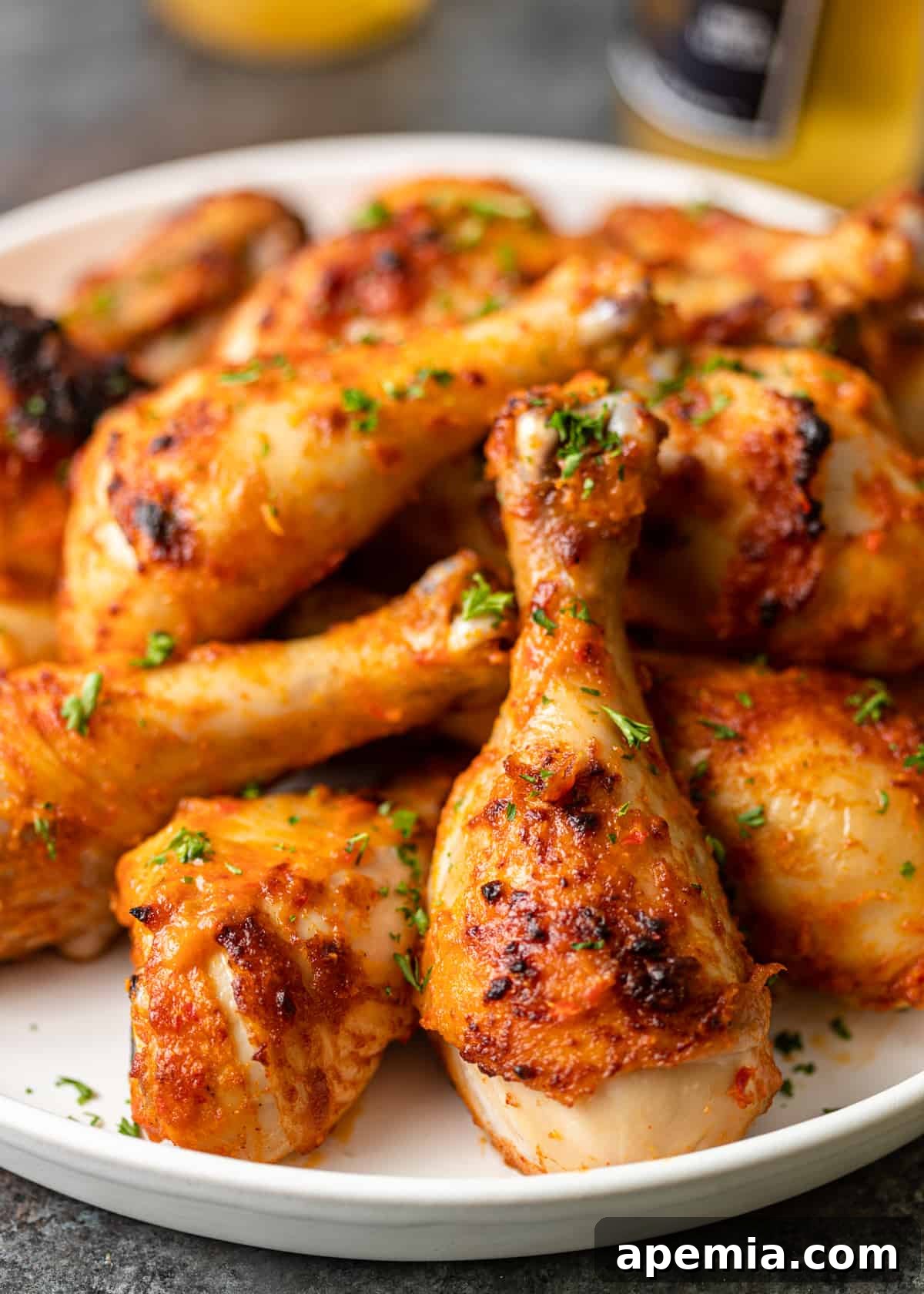 Fiery Peri Peri Chicken 3 White platter showcasing beautifully cooked Peri Peri Chicken with fresh herbs