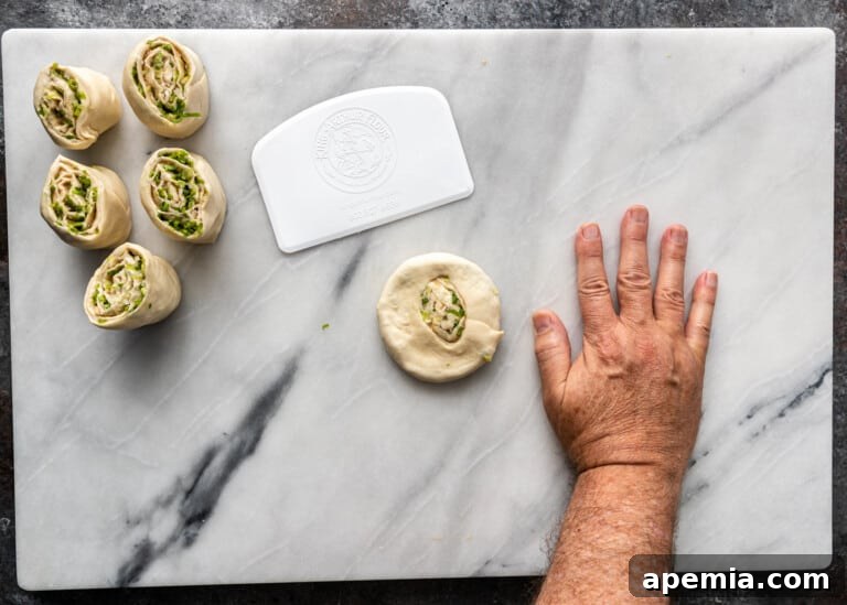 overhead process shot: pressing down on dough to form green onion pancakes