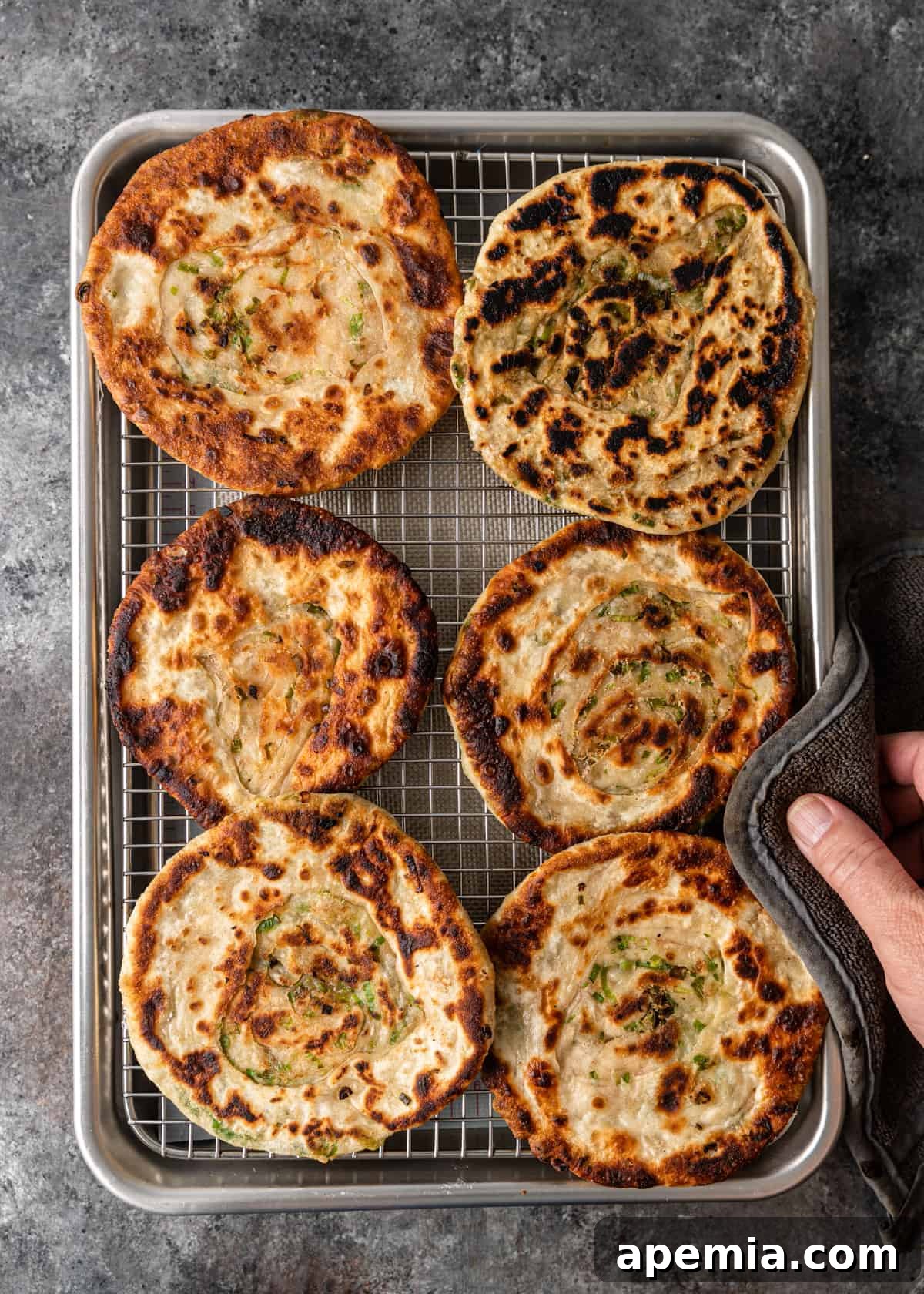 overhead: pan with freshly fried Chinese green onion pancakes, golden and crispy
