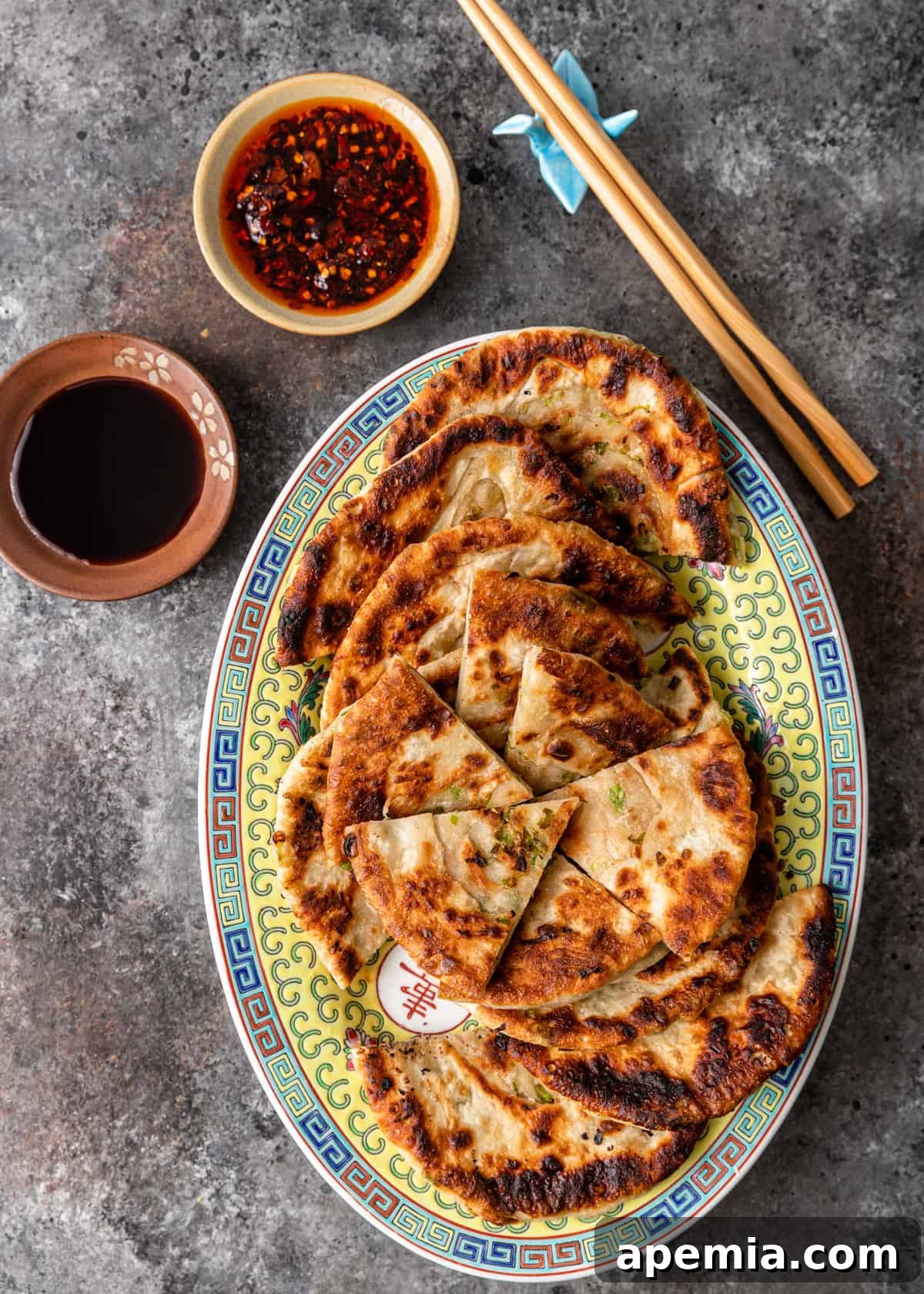 overhead: cut scallion pancakes arranged beautifully on a platter