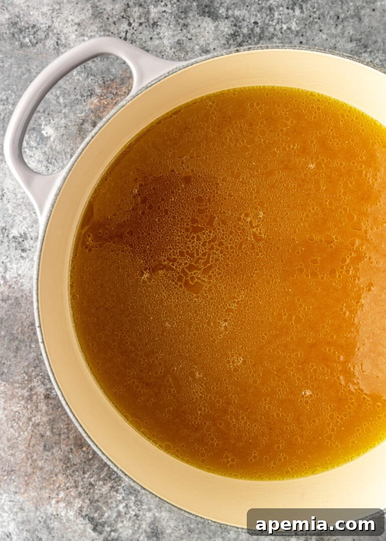 overhead process shot: titled image (and shown) "strained broth"