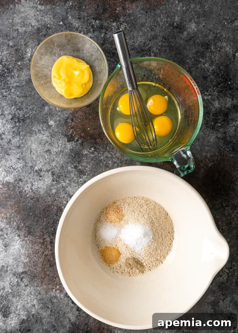 overhead process shot: eggs in measuring cup and seasonings to make matzo ball soup in bigger mixture bowl