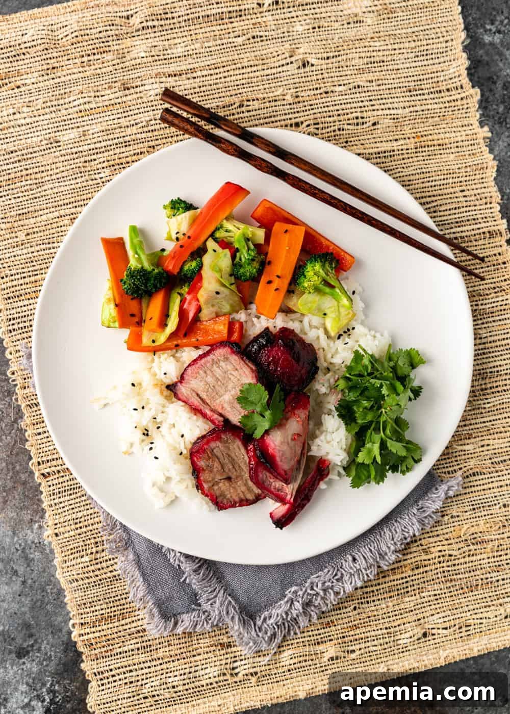 Overhead view of a plated serving of Char Siu with a side of roasted carrots and broccoli, creating a complete and balanced meal.