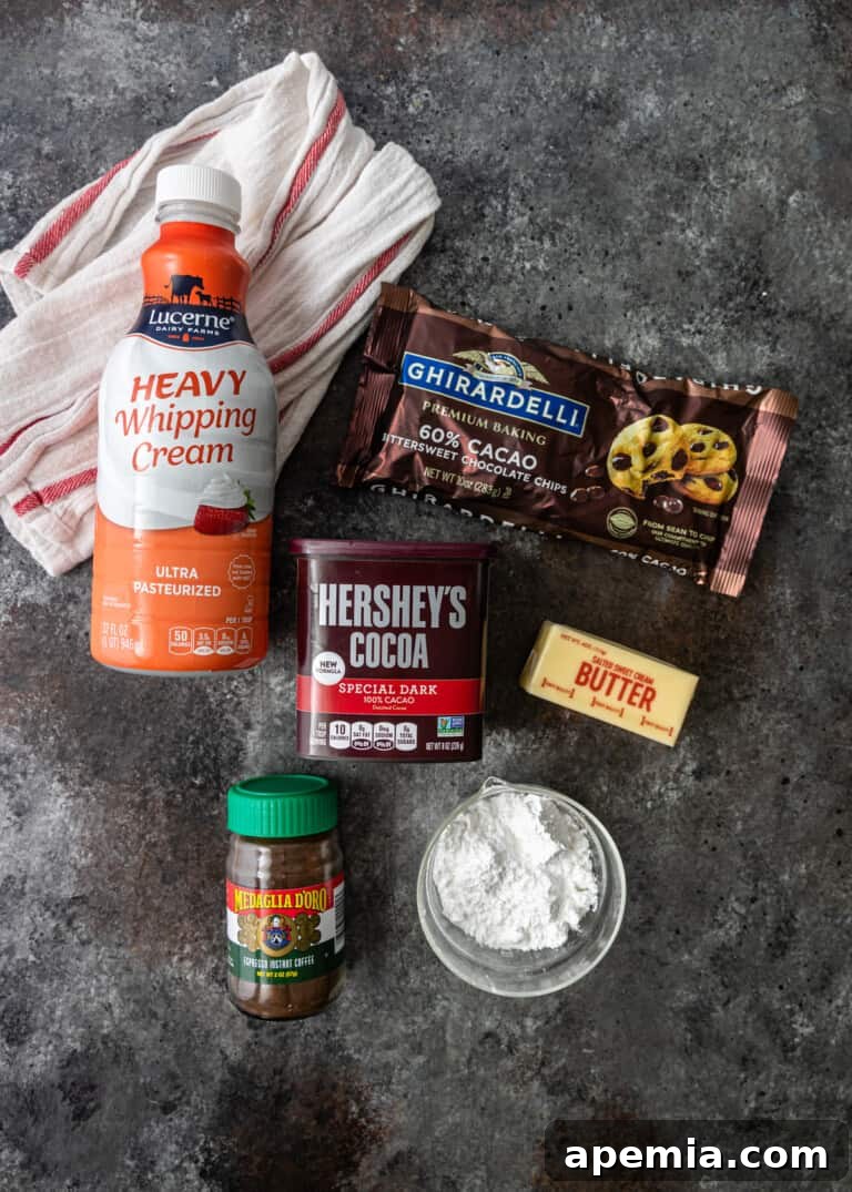 Overhead process shot: Ingredients for the chocolate filling, including chocolate chunks, cocoa powder, and powdered sugar, arranged on a counter.