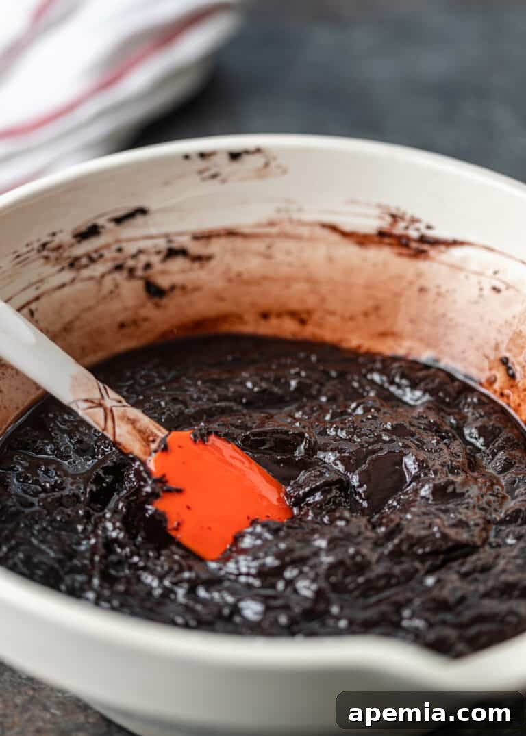 Close-up process shot: Smooth, glossy chocolate mixture for the babka filling in a white bowl, ready to be chilled.