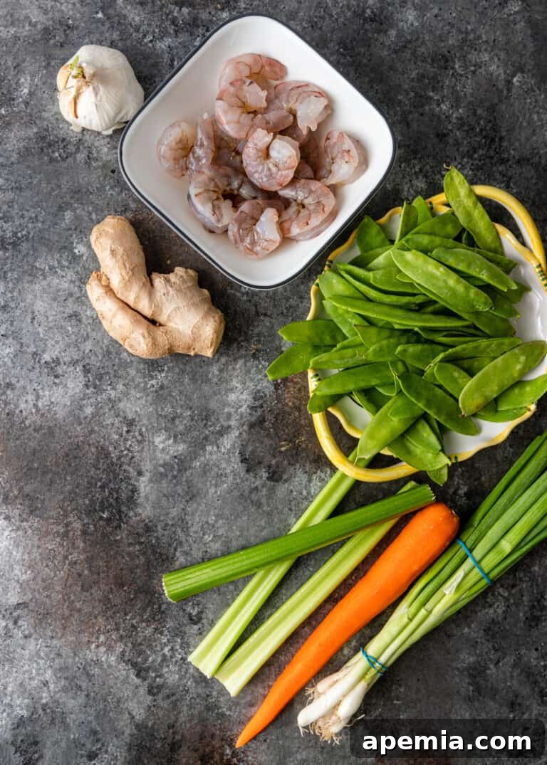 Assorted fresh ingredients for shrimp and snow peas, neatly arranged before preparation.