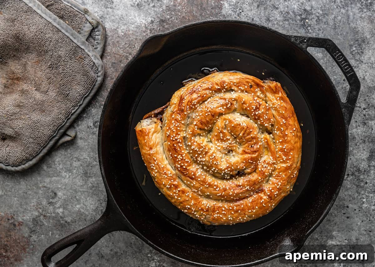overhead: cooked meat filled pastry in a cast iron skillet