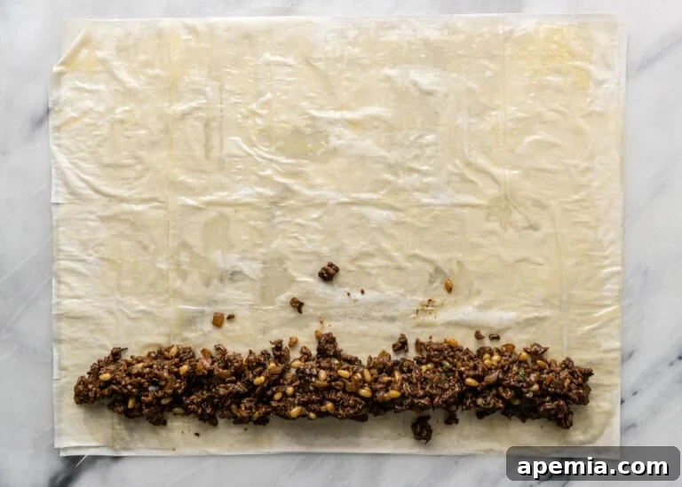 overhead process shot: adding meat filling to pastry