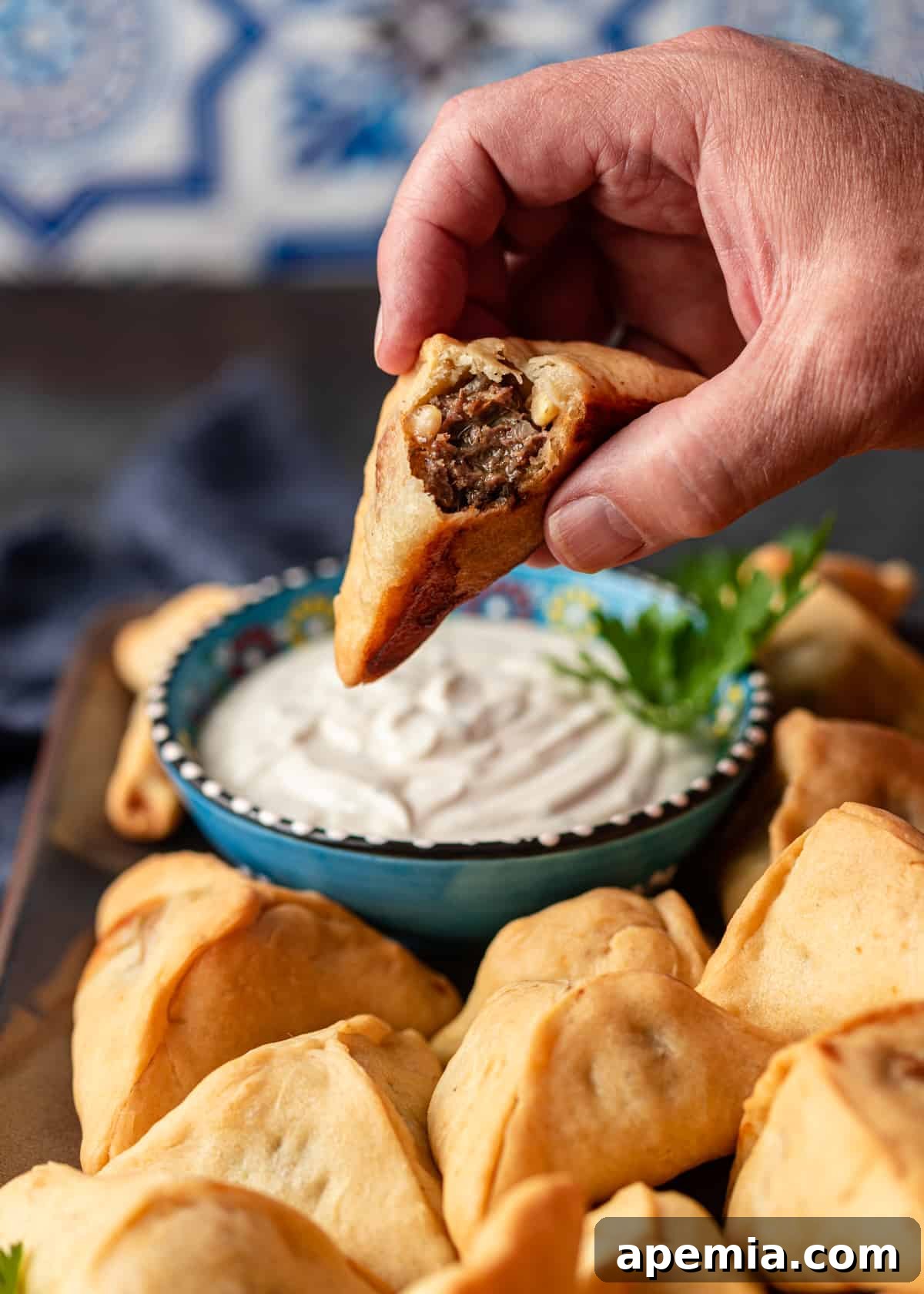 closeup: my fatayer recipe with a bite taken out to show meat filling