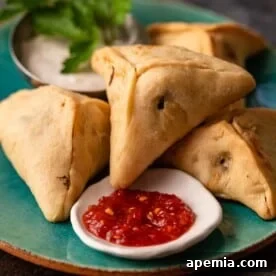 fatayer appetizer on plate with red shatta sauce
