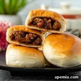 Chinese BBQ pork buns cut open and stacked on top of each other on plate