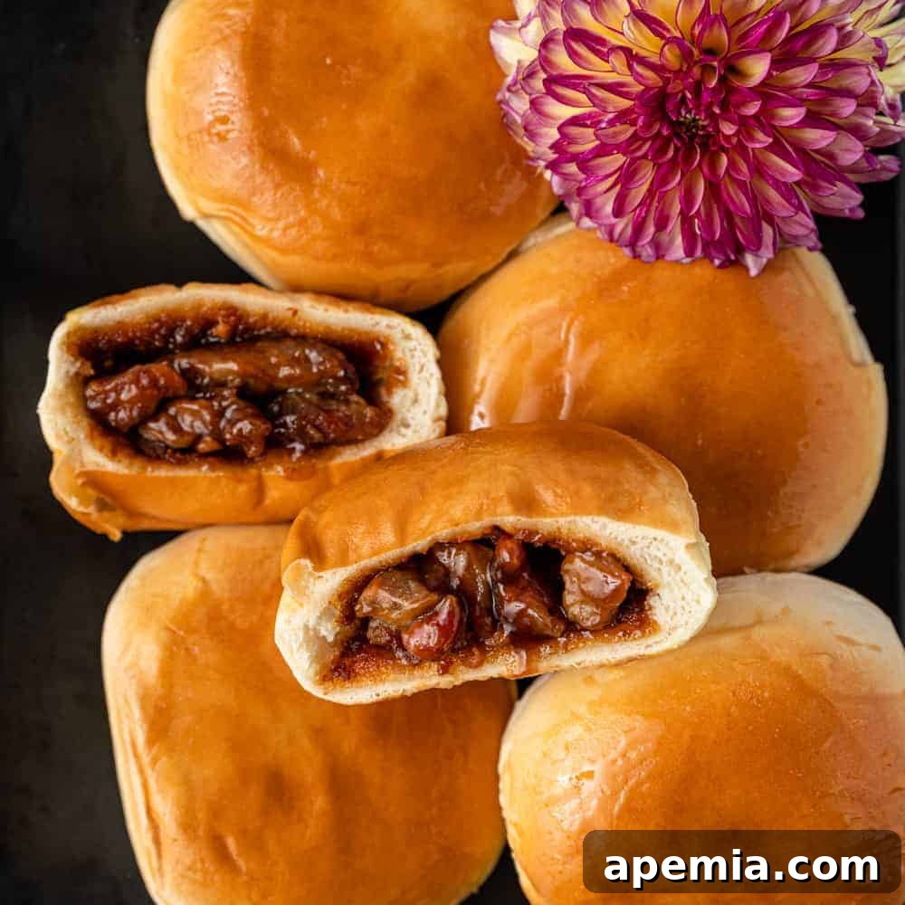 baked char siu bao cut in half stacked on whole buns