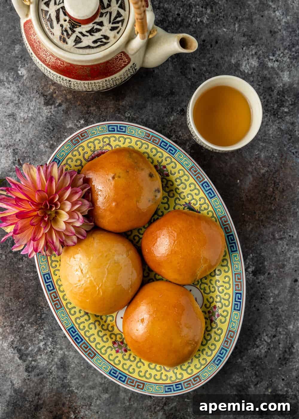 overhead: chinese BBQ pork buns char siu bao on a platter with tea