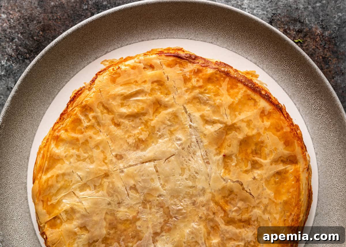 An overhead view of the beautifully baked Moroccan Pastilla, golden and crisp, ready for garnishing.