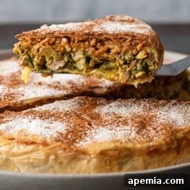A captivating image of a freshly baked Moroccan Pastilla, beautifully garnished with powdered sugar and cinnamon, ready to be served.