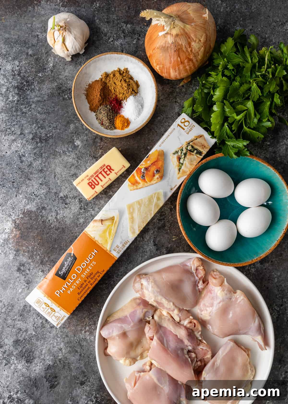 Overhead shot showcasing all the fresh, high-quality ingredients laid out and ready to make a traditional Moroccan Pastilla.