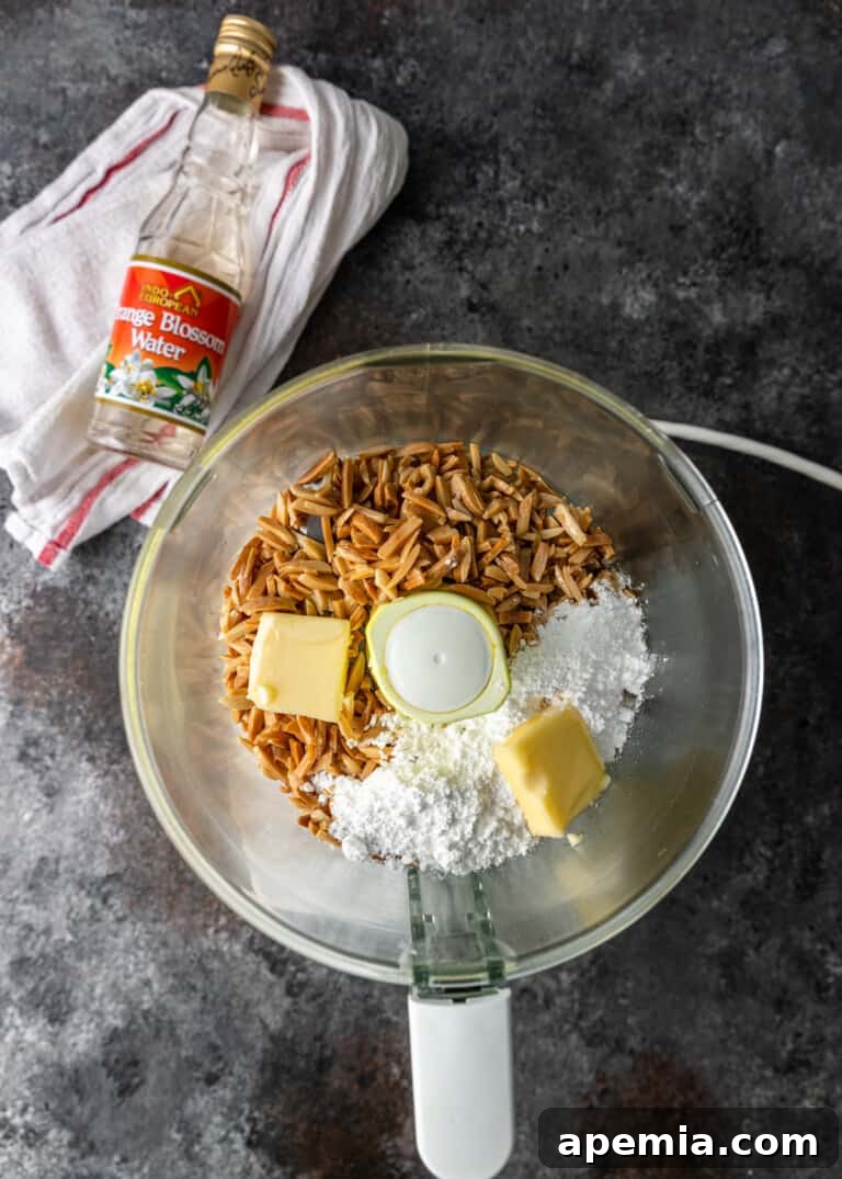 Process shot: Combining toasted almonds with powdered sugar, butter, and orange blossom water in a food processor.