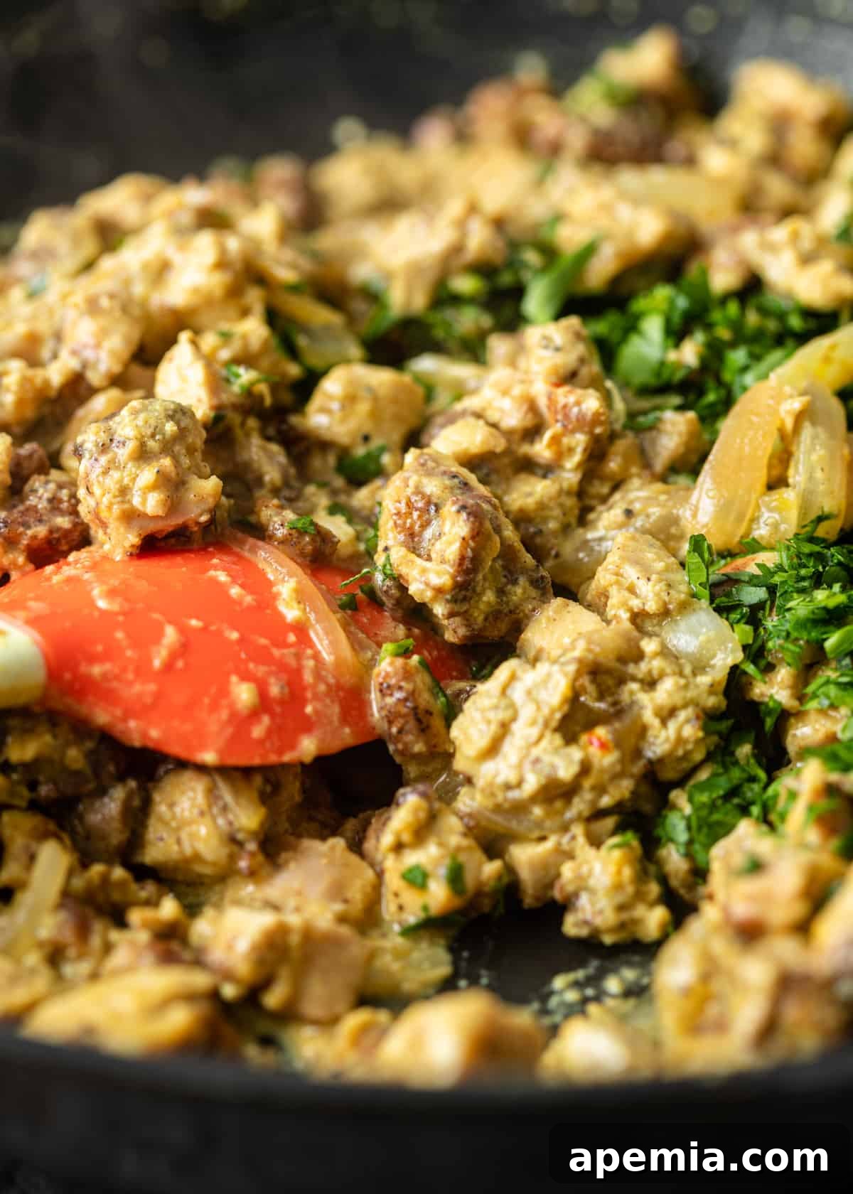 Process shot: Combining the chicken and egg mixture with fresh parsley in a skillet.