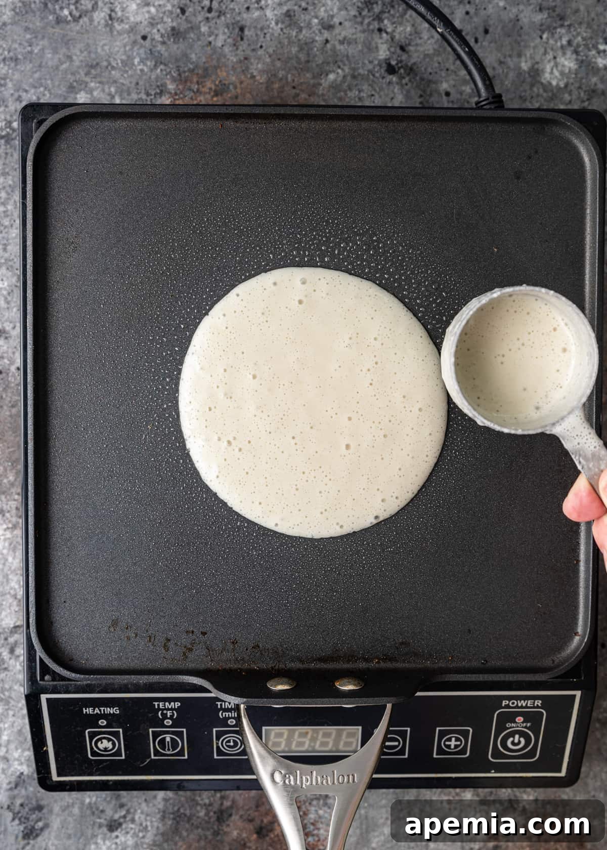 overhead: showing how to make dosa on griddle