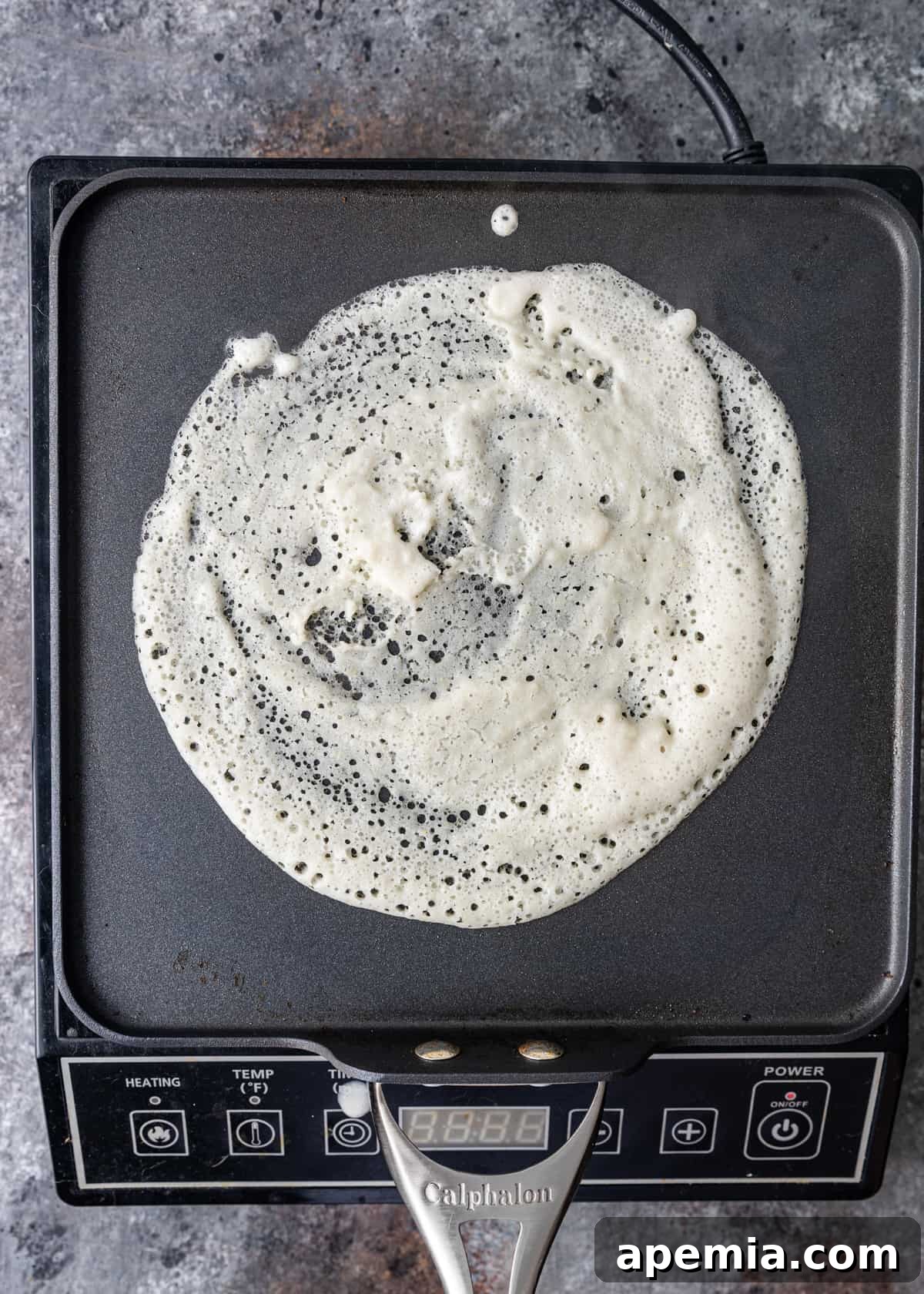 overhead: cooking dosa on griddle