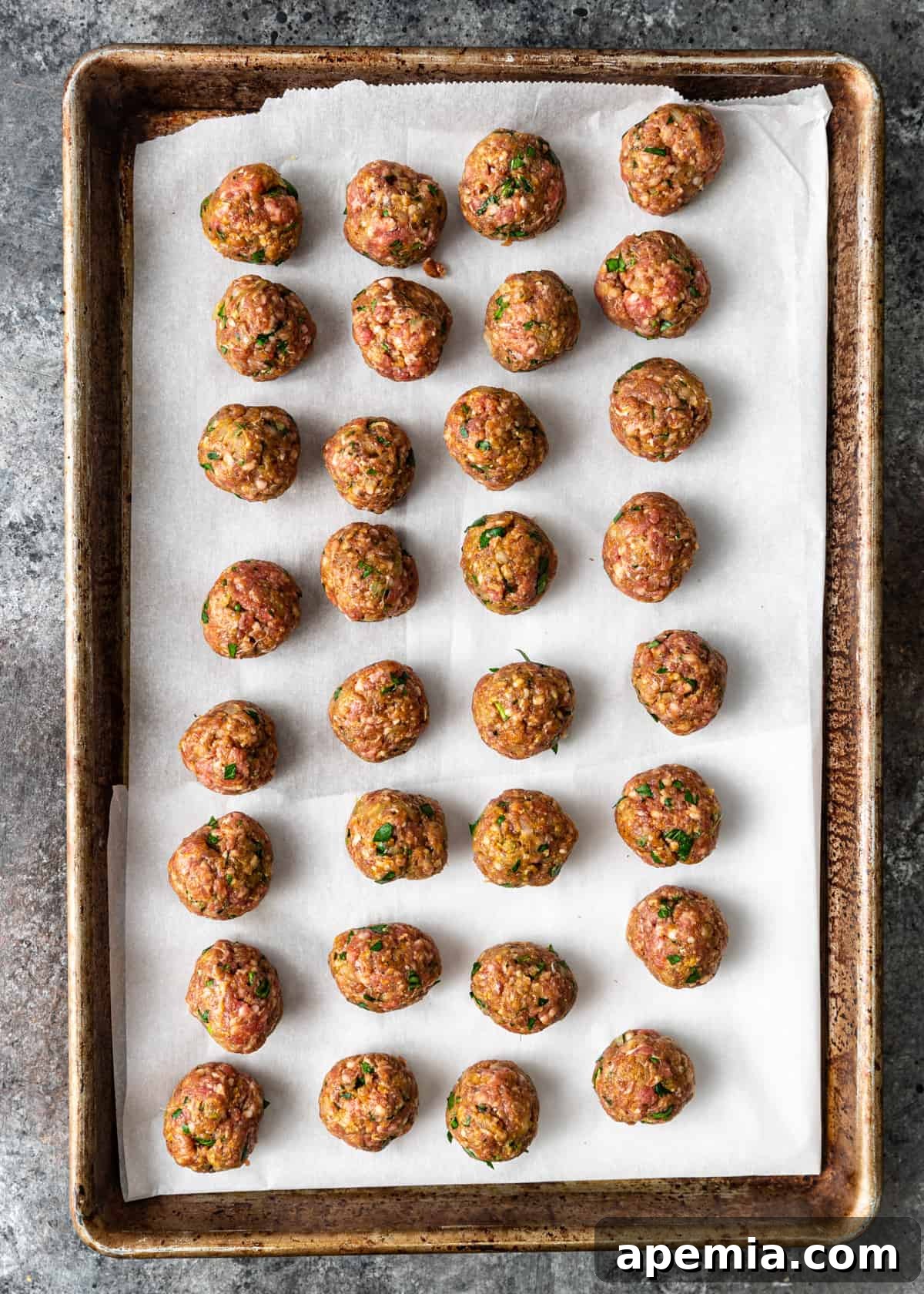 overhead process shot: uncooked moroccan lamb meatballs shaped and ready