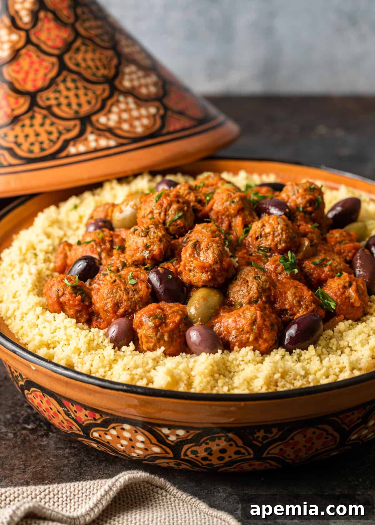 closeup side view: bowl filled with moroccan meatballs and sauce